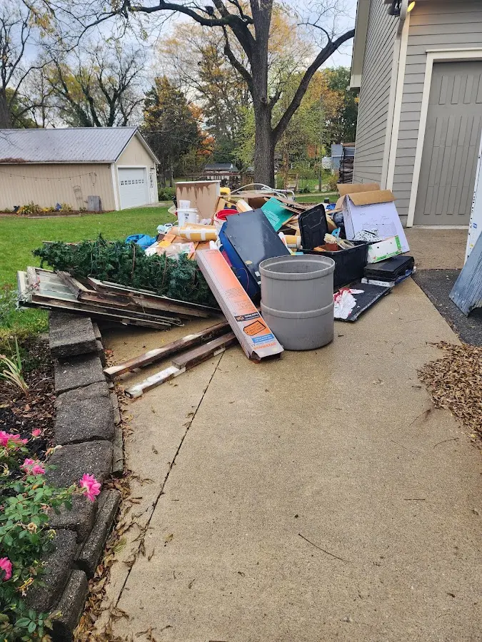 Dumpster being loaded with debris for Estate Cleanout Dumpster Rental in Eidson Road